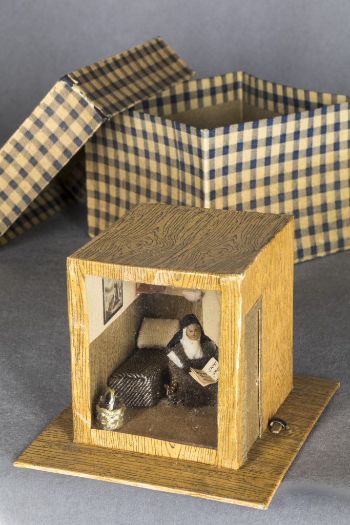 Figure 6 Carmelite Cell with box for transport, 19th century, Made of wax, fabric, paper, cardboard, straw, shells, and glass. 7.8 x 9.7 x 10.6 cm Photo: Jean-Michel Gobillot, Courtesy of Thierry Pinette