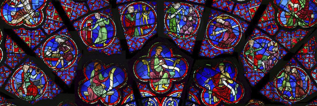 Fig. 7 The upper mid-section of the western rose of Notre-Dame of Paris, detail of Fig. 4, with images of the vices from the upper half of the window (left to right): Luxuria (K-6), Avarice (L-5, well preserved), Inconstancy (L-6, modern), Idolatry (A-5), Anger (A-6), Despair (B-5), Ingratitude (B-6), and Discord (C-5) (Photo by kind permission of Christian Dumolard).
