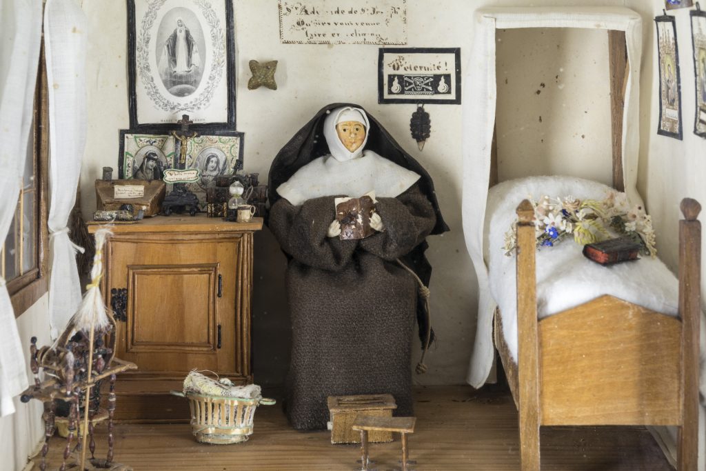 Figure 2 Cell of Sister Adélaïde, a Tertiary nun of the Franciscan order, 19th century, Made of wood, fabric, paper, cardboard, vegetal fiber, wax, metal, and glass. 30.5 x 34.5 x 22.5 cm Photo: Jean-Michel Gobillot, Courtesy of Thierry Pinette