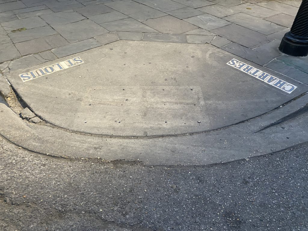 A grey cement and stone sidewalk.