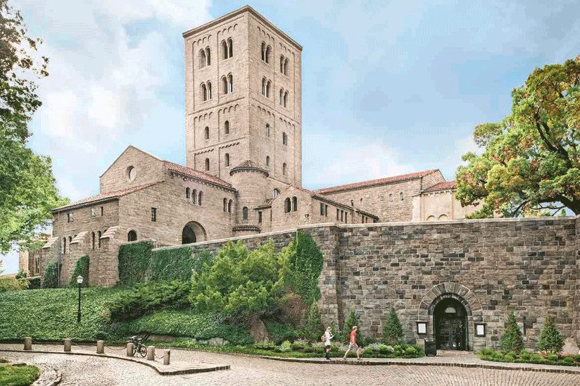 The Met Cloisters, a medievalizing stone building with a tower.