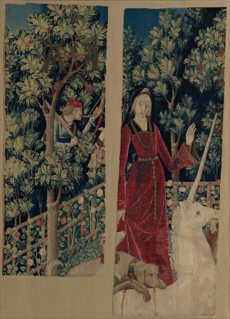 Tapestry showing a unicorn and a woman wearing a lavish red dress.
