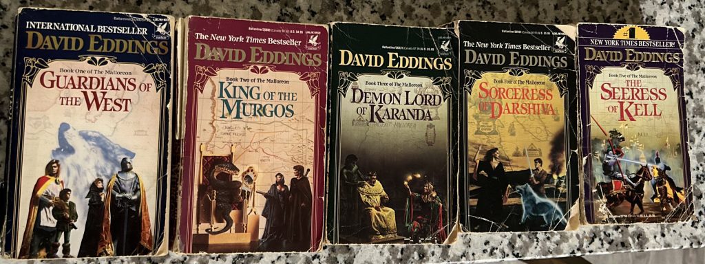 Five books side-by-side in a row.