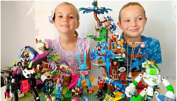 Two children play with Lego sets that include a dark unicorn, a blue roller-skating bunny, a green slime robot, and tree houses.