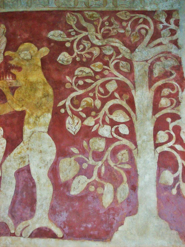 Detail of tree in mural painting with round fruit and a snake winding through the branches.