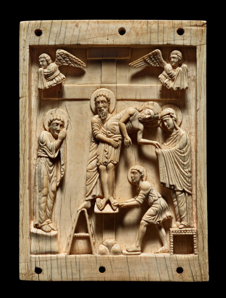 Deep-carved relief of three figures lowering a fourth from a cross. A fifth figure stands to the left and two angels hover above.