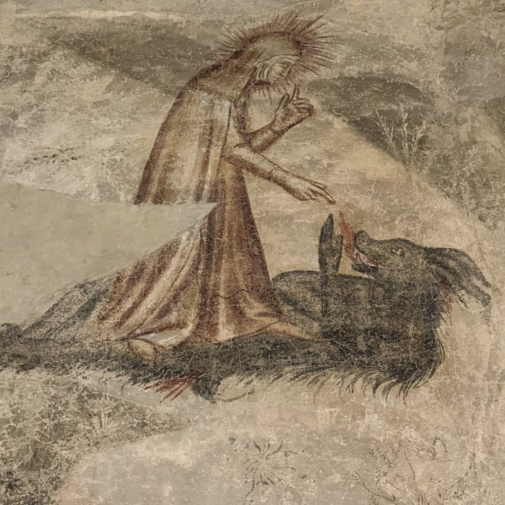 Woman stands over boar.