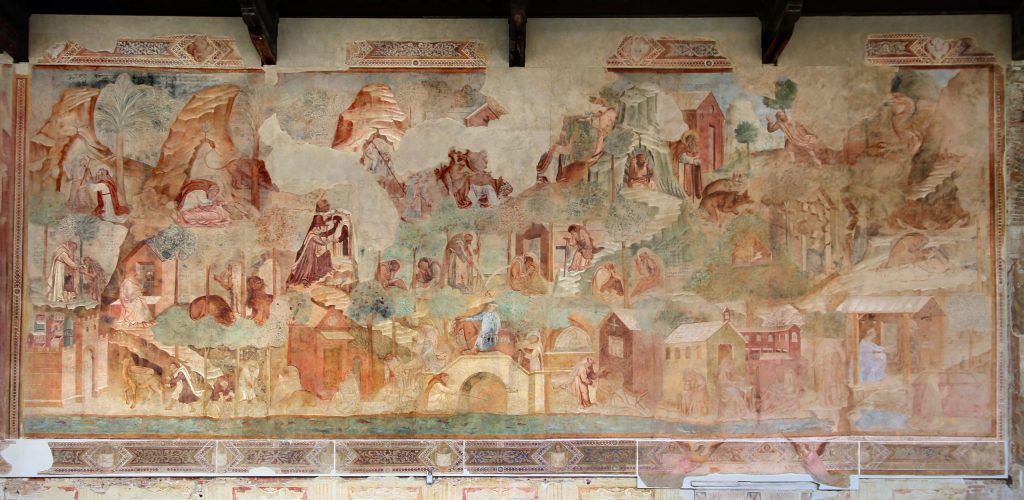 A large rectangular wall painting in which many figures from early stories about hermits in the desert are pictured in an elaborate landscape setting.