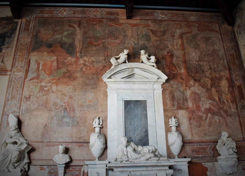bove and to either side of a later stone monument, there is what remains of an early religious wall painting showing Jesus Christ dying on the cross and many other figures in a landscape.