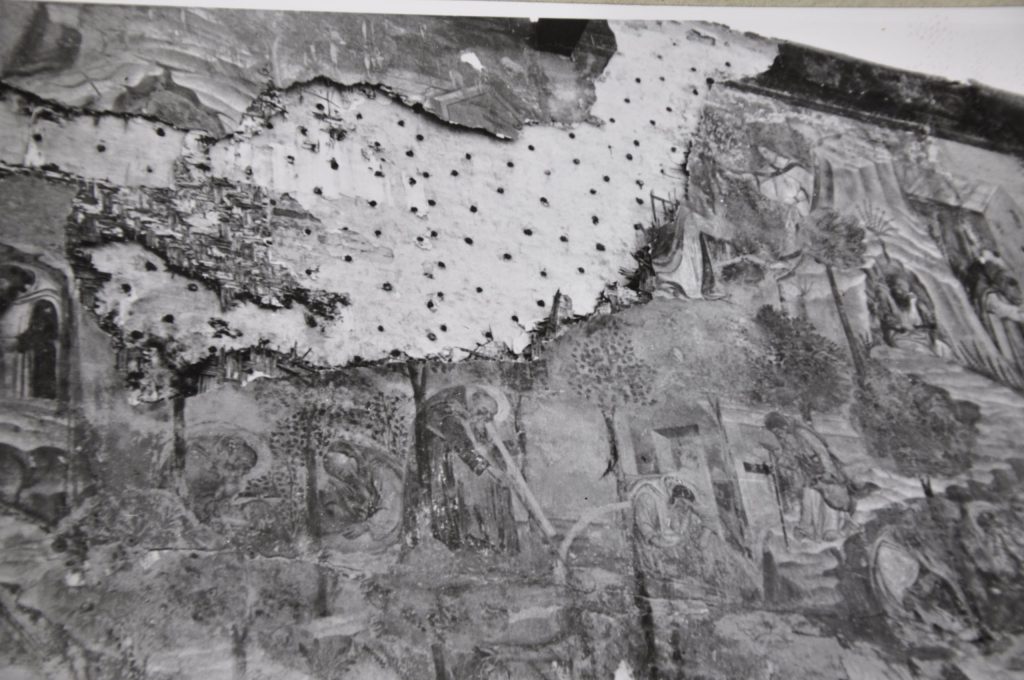 Black-and-white photograph from World War Two showing part of a wall painting that was damaged during the war.