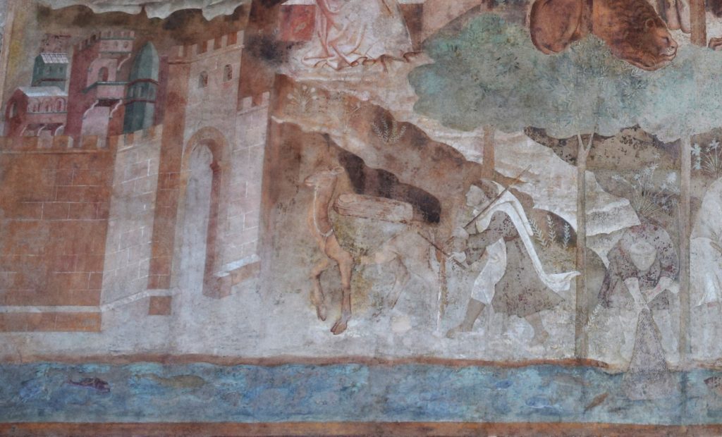 Part of a wall painting showing a camel caring a load on its back and a young man just behind.
