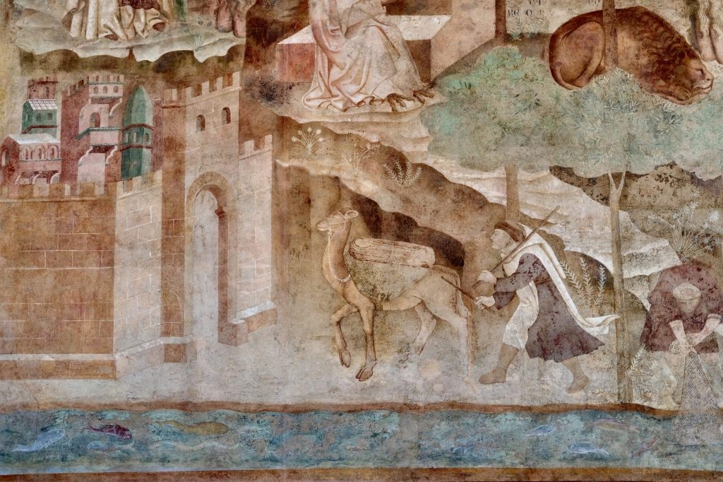 Detail of the Thebaid fresco, showing a young monk driving his laden camel towards the gate of a city, by the bank of a river.