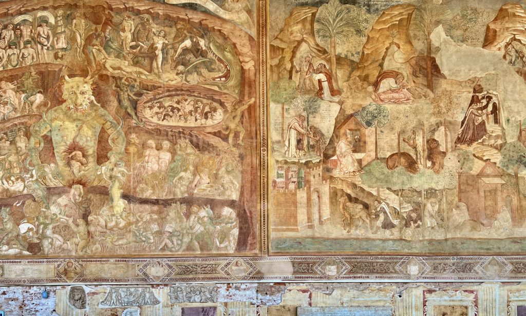 Parts of Buffalmacco’s frescoes of Hell and the Thebaid, next to each other on the southern wall of the Camposanto. The large figure of Satan squats in the centre of Hell. The monk shown in Figure 11 can be seen at the bottom left-hand corner of the Thebaid.