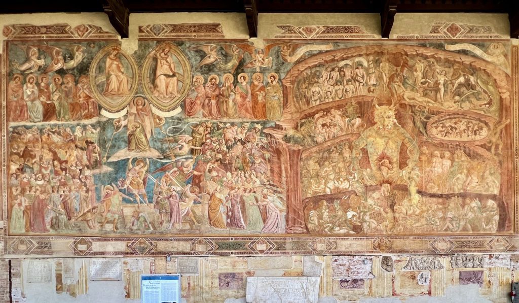 Buffalmacco’s fresco of The Last Judgment and Hell in the Camposanto. On the upper left, the Virgin Mary and Christ can be seen in mandorlas. The damned are being forced through the gates of Hell, depicted as a series of underground torture chambers in the right-hand half of the fresco.