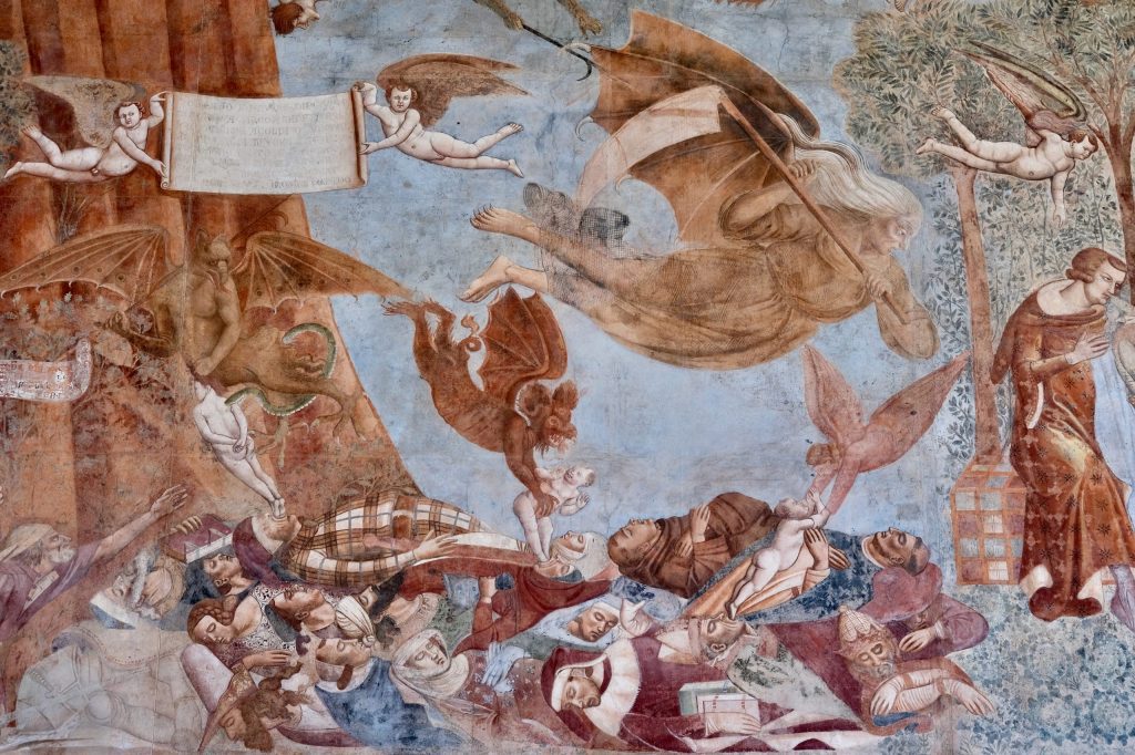 Detail of The Triumph of Death, showing the figure of Death as a bat-winged hag wielding a large scythe, flying above a pile of newly-dead corpses whose souls are being gathered by angels and demons.