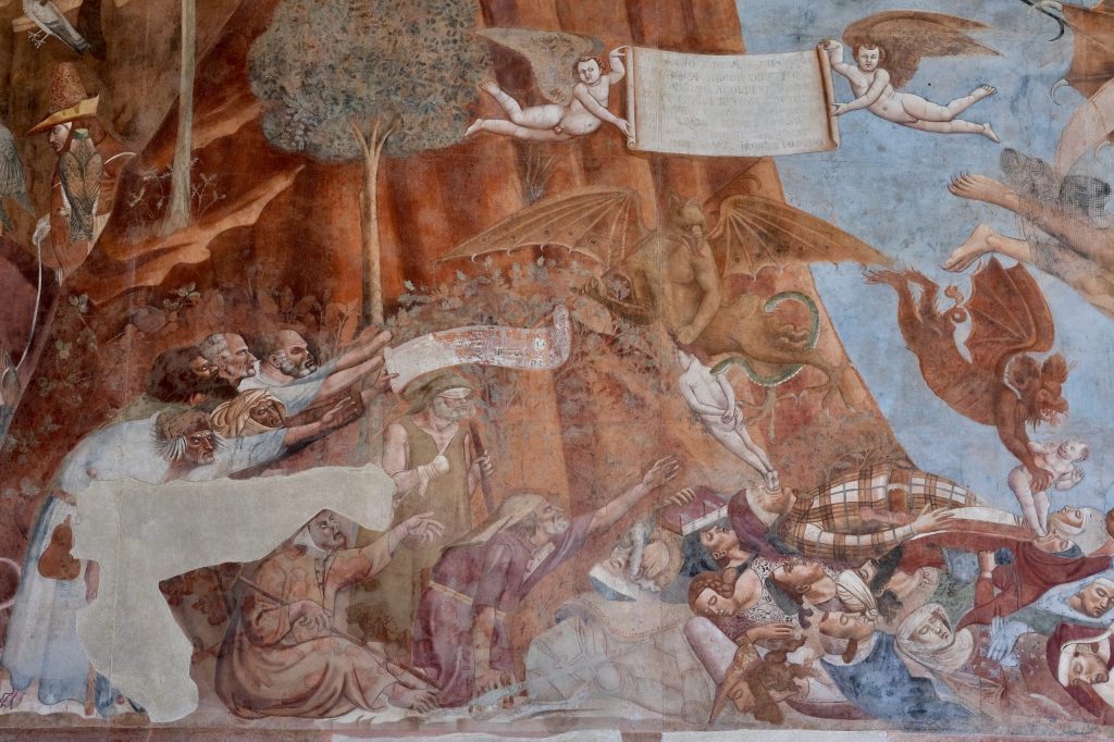 Detail of The Triumph of Death, with a group of old, diseased and crippled men and women calling out to Death to end their sufferings, next to a pile of Death’s latest victims.