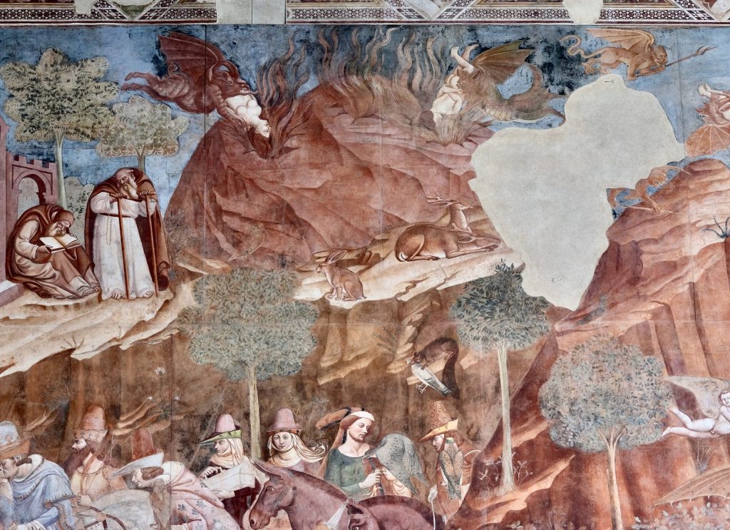 Detail of The Triumph of Death. Behind and to the right of the hermitage is a volcanic mountain issuing flames and smoke from fissures and caves, into which winged demons are delivering the souls of dead people.