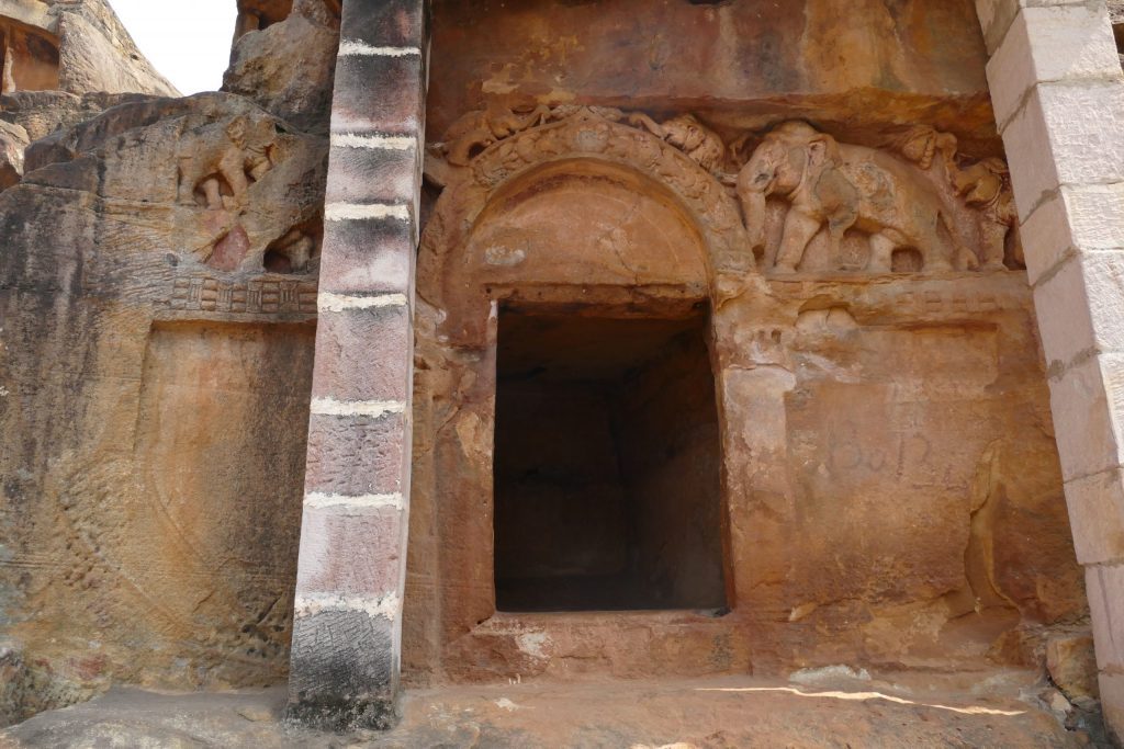 Rock-cut cave with arched entrance, relief of elephants above lintel. Udayagiri, Odisha.