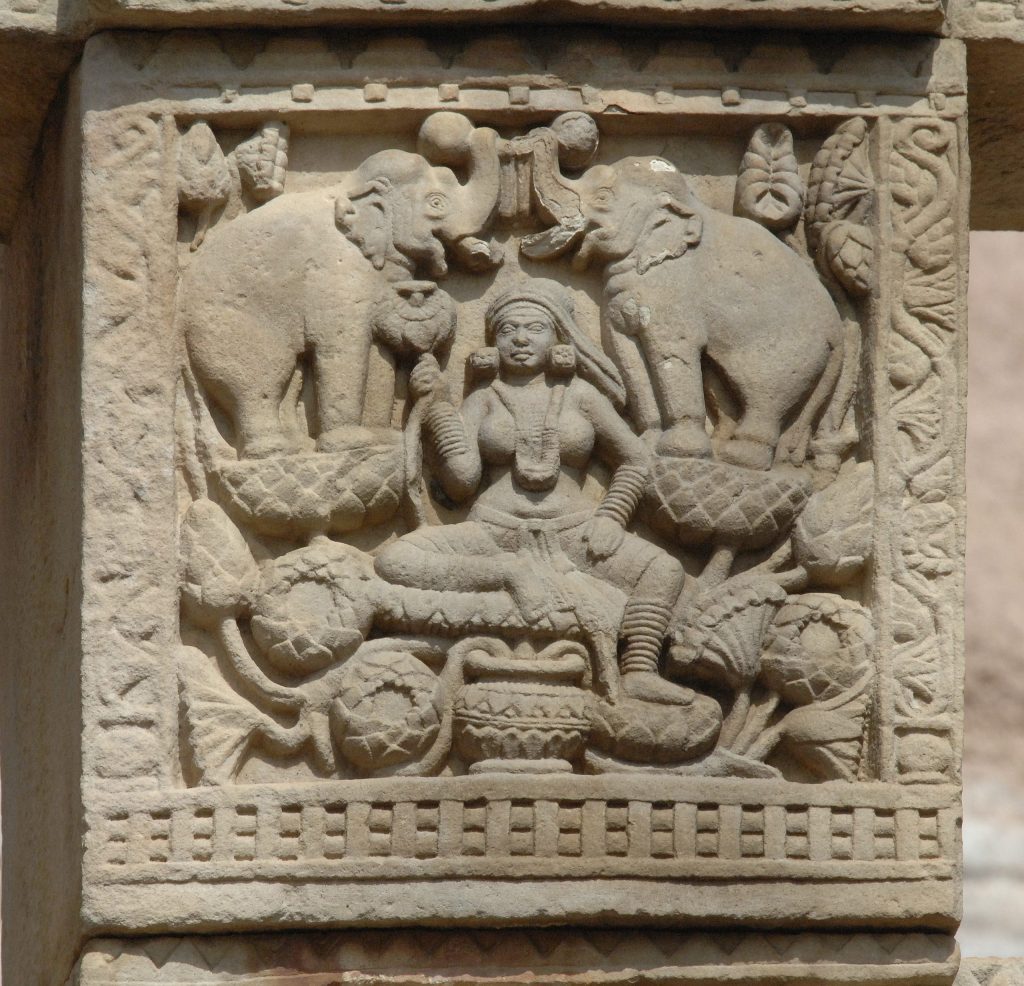 Stone relief of Gajalakshmi. Lakshmi is lustrated by two elephants, among proliferating lotus flowers. Sanchi stupa.