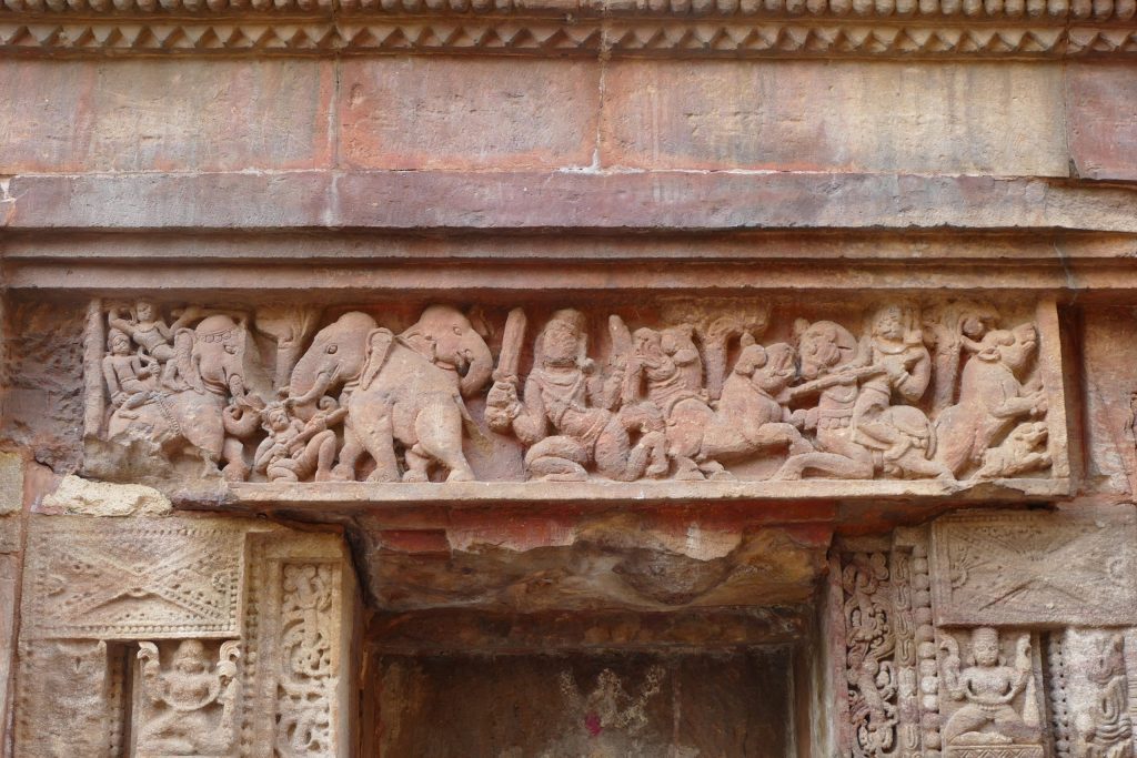 Stone relief on temple lintel. Hunt scene with elephant rider, a horse, and foot soldiers, elephants, lions and buffaloes. Parasuramesvara, Bhubaneswar, Odisha.
