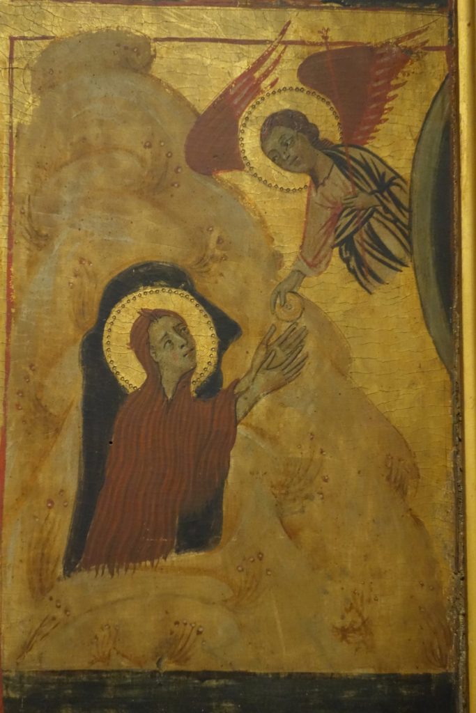 A detail from the Accademia Vita Panel, which shows the scene on the right side, second register from bottom, with the Magdalen facing right, kneeling within the mouth of her cave receiving Communion from an angel who is flying in from the left.