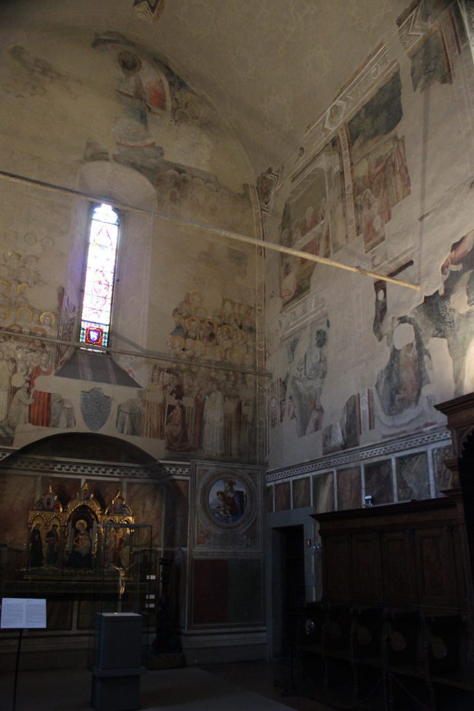 A view inside the Bargello Chapel in Florence. On the (former) altar wall to the left is a much ruined fresco of the Last Judgment. On the right wall are two registers of badly damaged scenes of the life of the Magdalen.