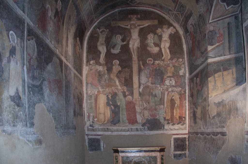 A view into the Magdalen Chapel in San Domenico in Spoleto. The altar wall features a large fresco of the Crucifixion. The side walls contain a cycle of the life of Mary Magdalen.