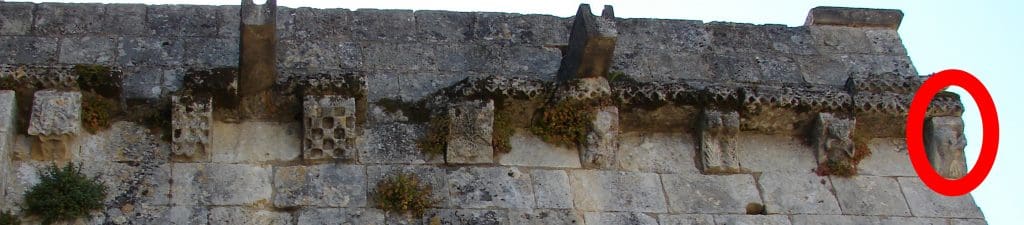 The bearded horn blower shown in situ high on a corner of a Romanesque church.