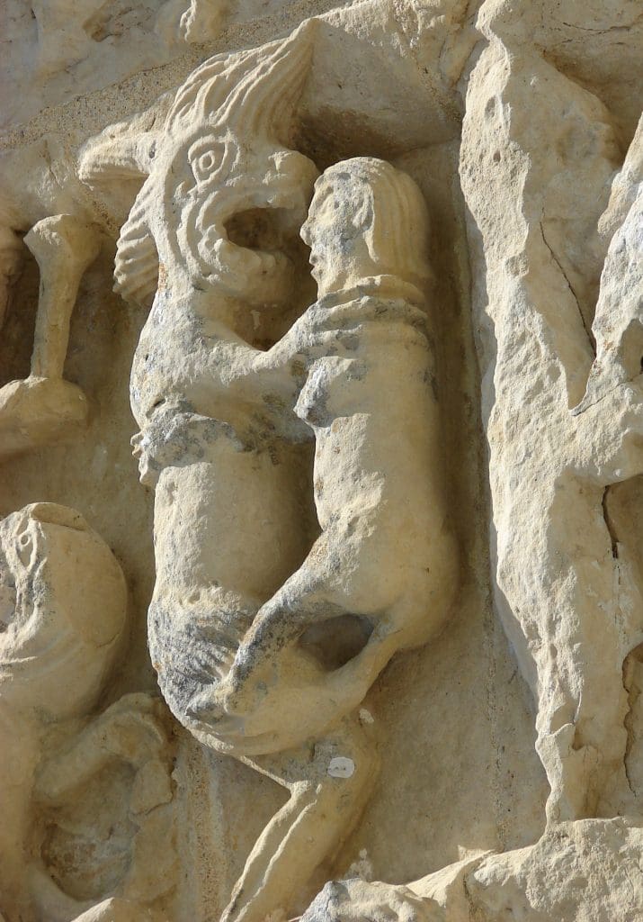 A therianthropic beast sodomizes a humanoid figure with its phallic tail.