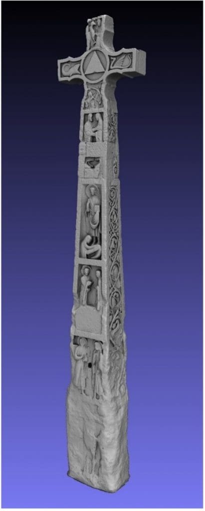 An oblique view of a greyscale, three-dimensional rendering of the Ruthwell Cross. The front has multiple panels which show scenes from the life of Christ. The border around each panel has Latin inscriptions in Roman alphabet. The right side of the cross depicts vine scroll along the entire length, with a runic inscription in the border.