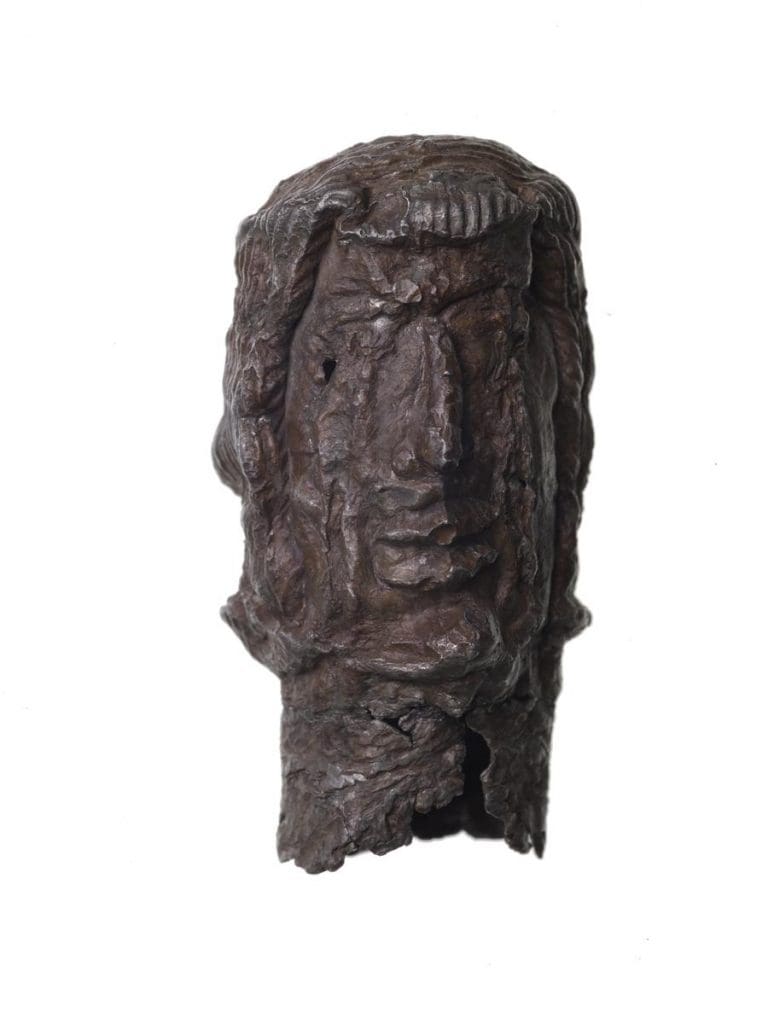 A fragment of a pilgrim badge showing the head of Christ with tears flowing from his eyes.