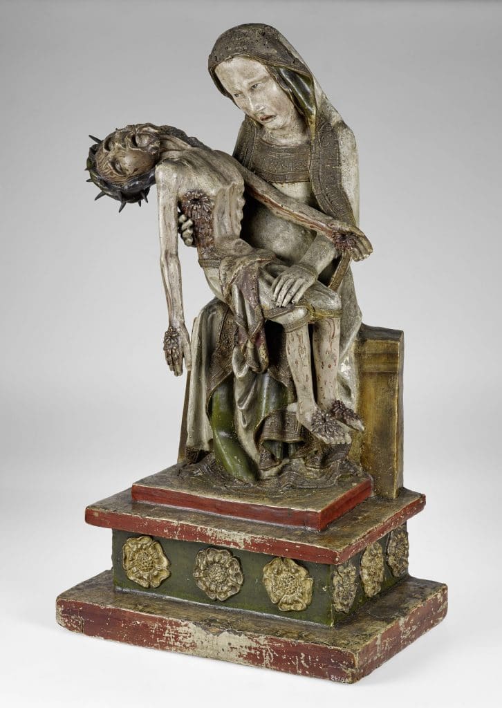 A sculpture depicting the Virgin Mary holding the dead Christ, whose body is marked with signs of his torture and death.