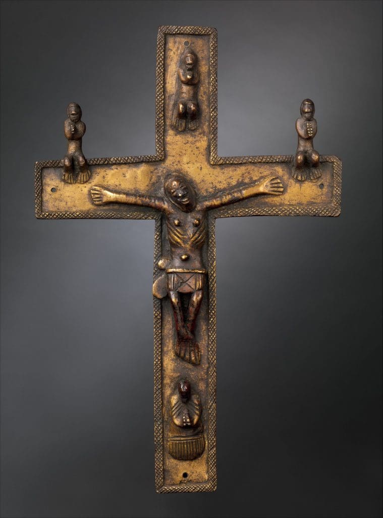 Bronze cross with crucified figure in the center and four smaller praying figures situated on each of the cross arms.