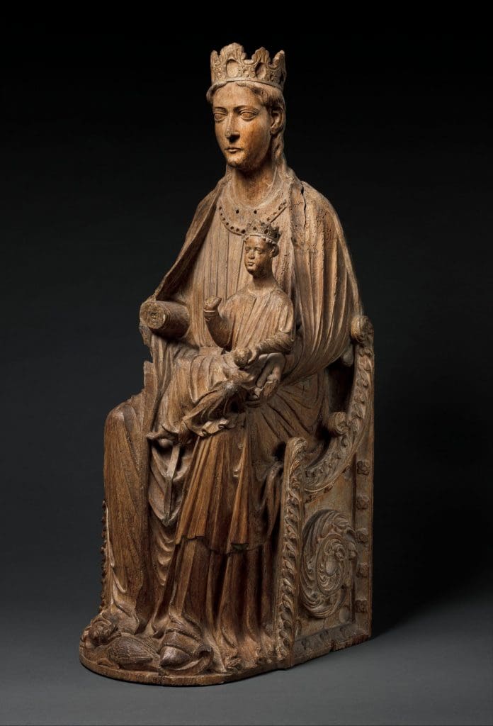 Fig. 7: A wooden statue of the Virgin seated and holding the infant Christ in her lap.