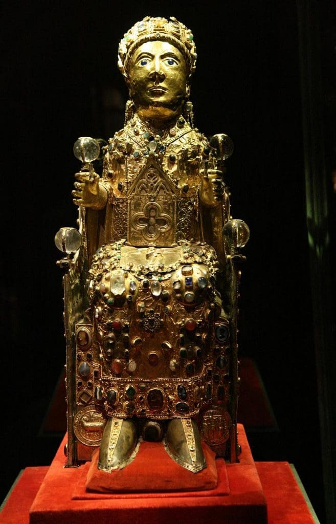 Fig. 9: A sculpture of a seated figure covered in gold and inset with numerous gemstones.