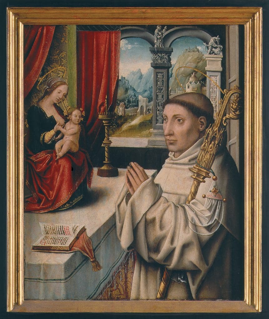 A painting showing a man with a shaved head wearing white robes with his hands raised in prayer before an image of a haloed woman wearing blue and red offering her breast to a small naked child with a halo.