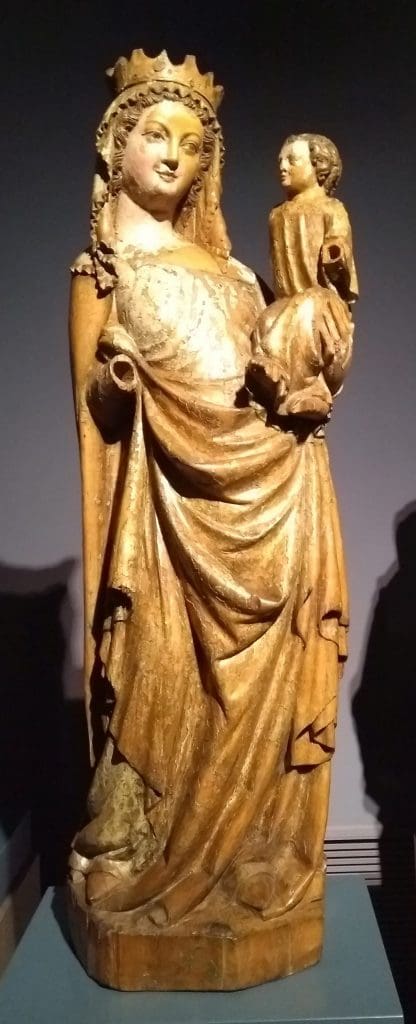 Photograph of a sculpture of a crowned woman holding a child in her left arm. The child’s head was designed to be movable in the context of religious dramas, probably dialogues between mother and child.