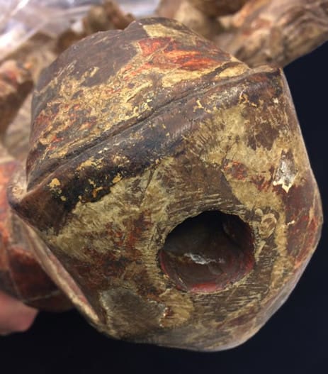 Close-up photograph of a wooden sculpture of a woman, showing a hole in the head, into which imitation tear liquid could be poured.